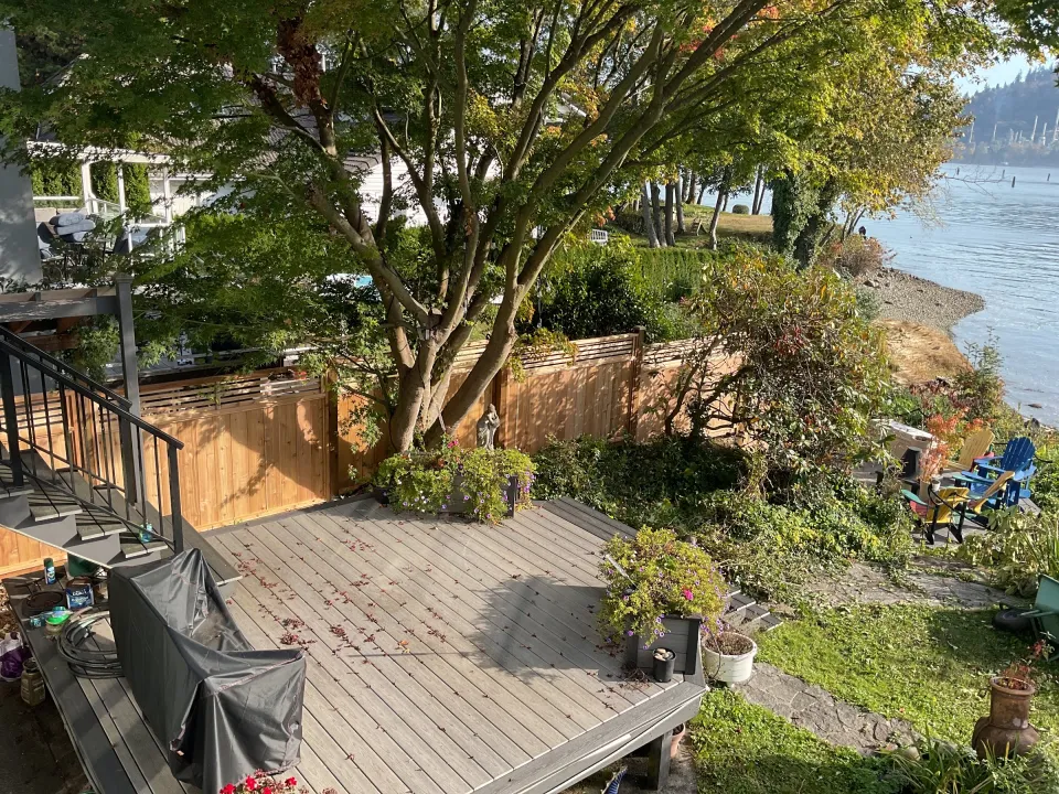 Framed cedar privacy fence along a deck and garden bed