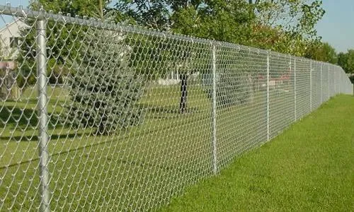 Galvanized chain link fence along a field