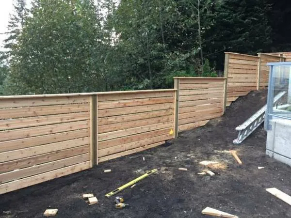 Stepped horizontal cedar fence on a sloped lot