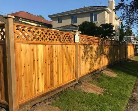 Cedar lattice-top fence beside a lawn