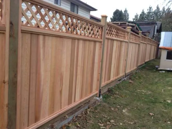 Long cedar fence with a diagonal lattice top along a backyard
