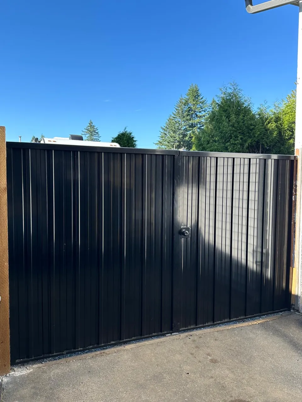 Black steel double gate across a driveway