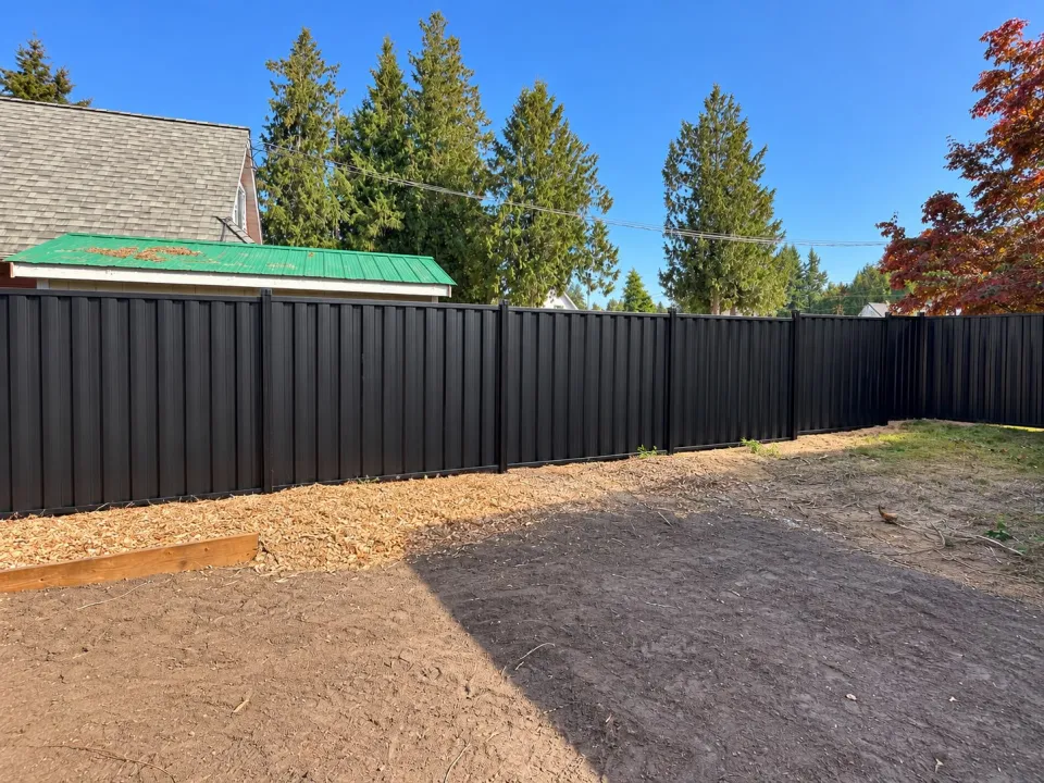 Black steel privacy fence around a newly levelled yard