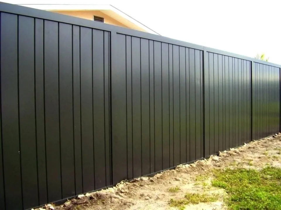 Close view of black steel privacy fence panels