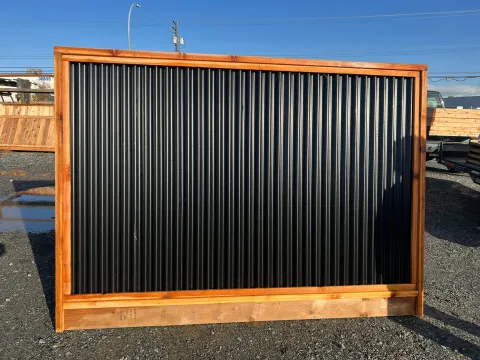 A finished cedar-framed black steel fence panel