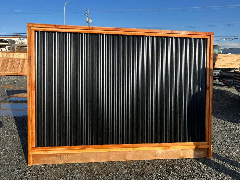 A finished cedar-framed black steel fence panel